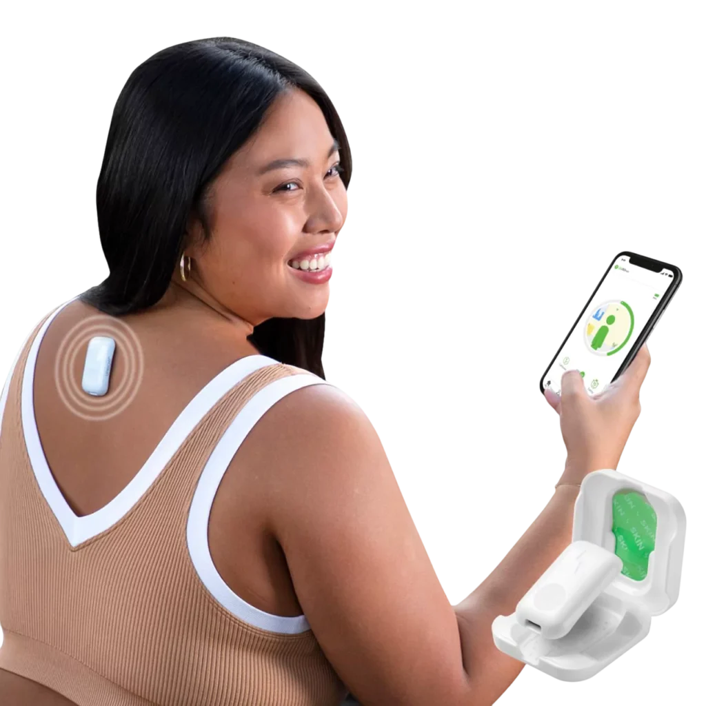Woman using Upright GO 2 Premium posture corrector device attached to upper back, while monitoring posture progress on smartphone app; portable posture trainer and tracker for women and men, supports real-time posture feedback, best posture corrector with app, improve back health, and wearable device for posture alignment.